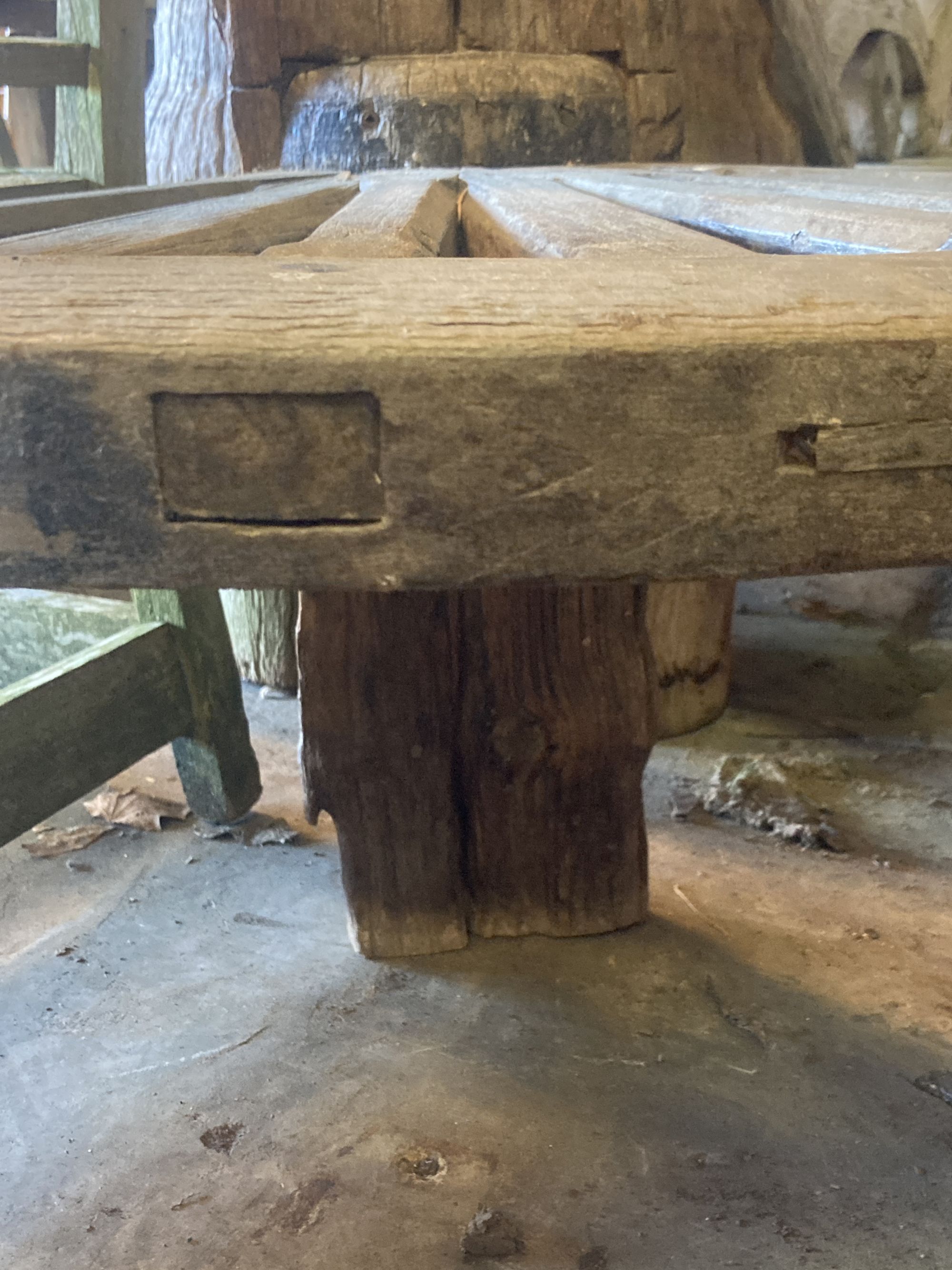 A weathered hardwood cartwheel and reclaimed timber garden seat, width 88cm depth 70cm height 170cm